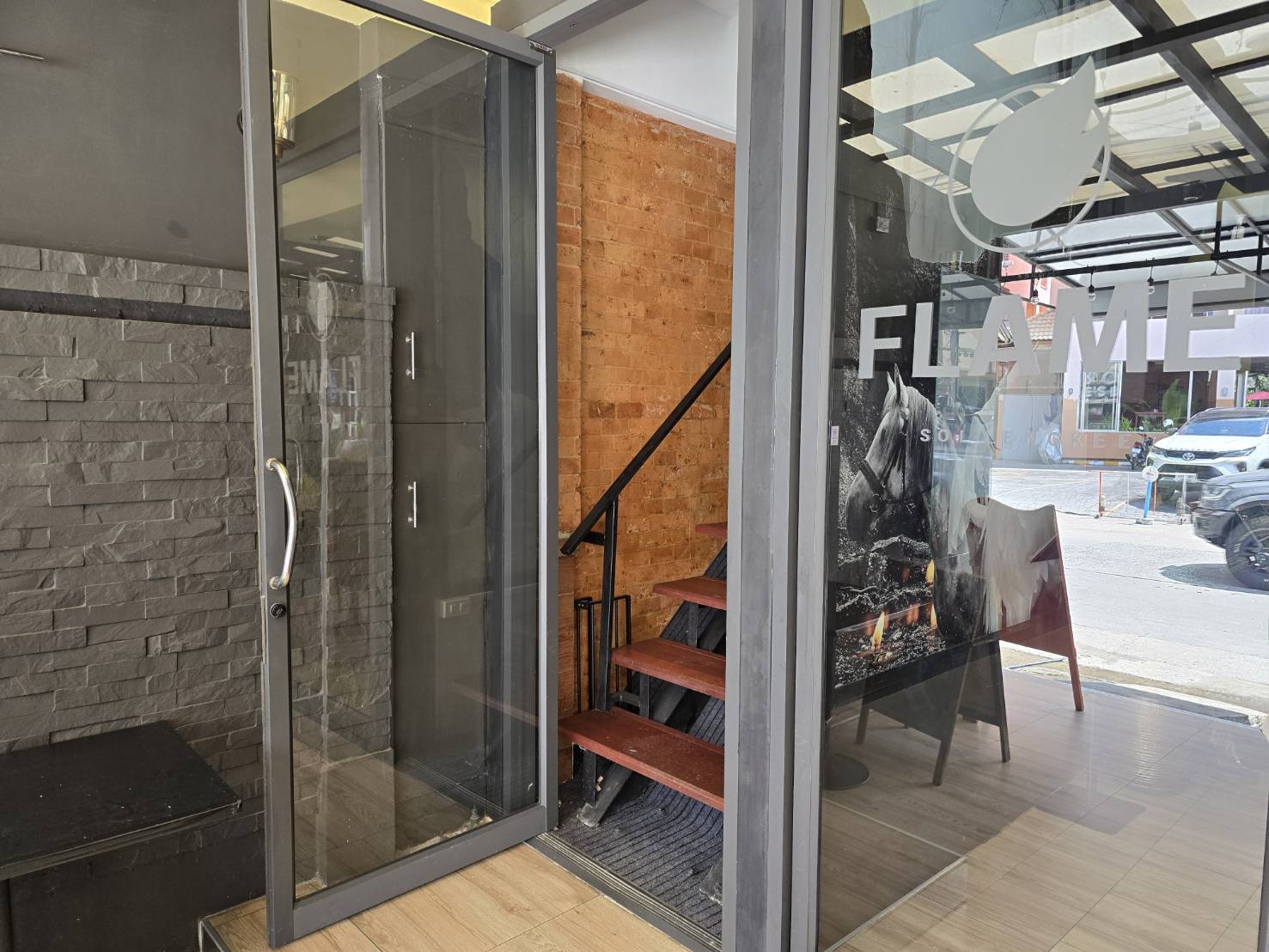 Actual glass door and internal stairs at Flame